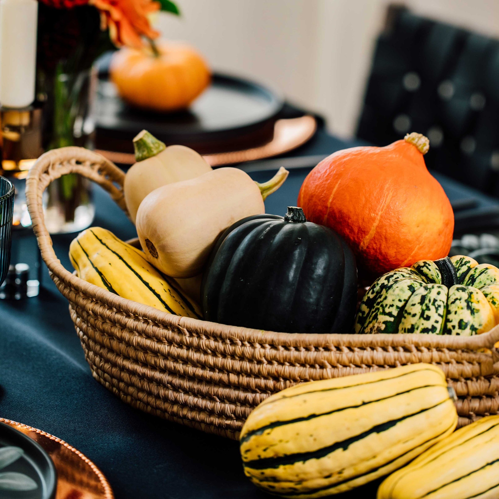 Basket of gourds on a table with a blurred background