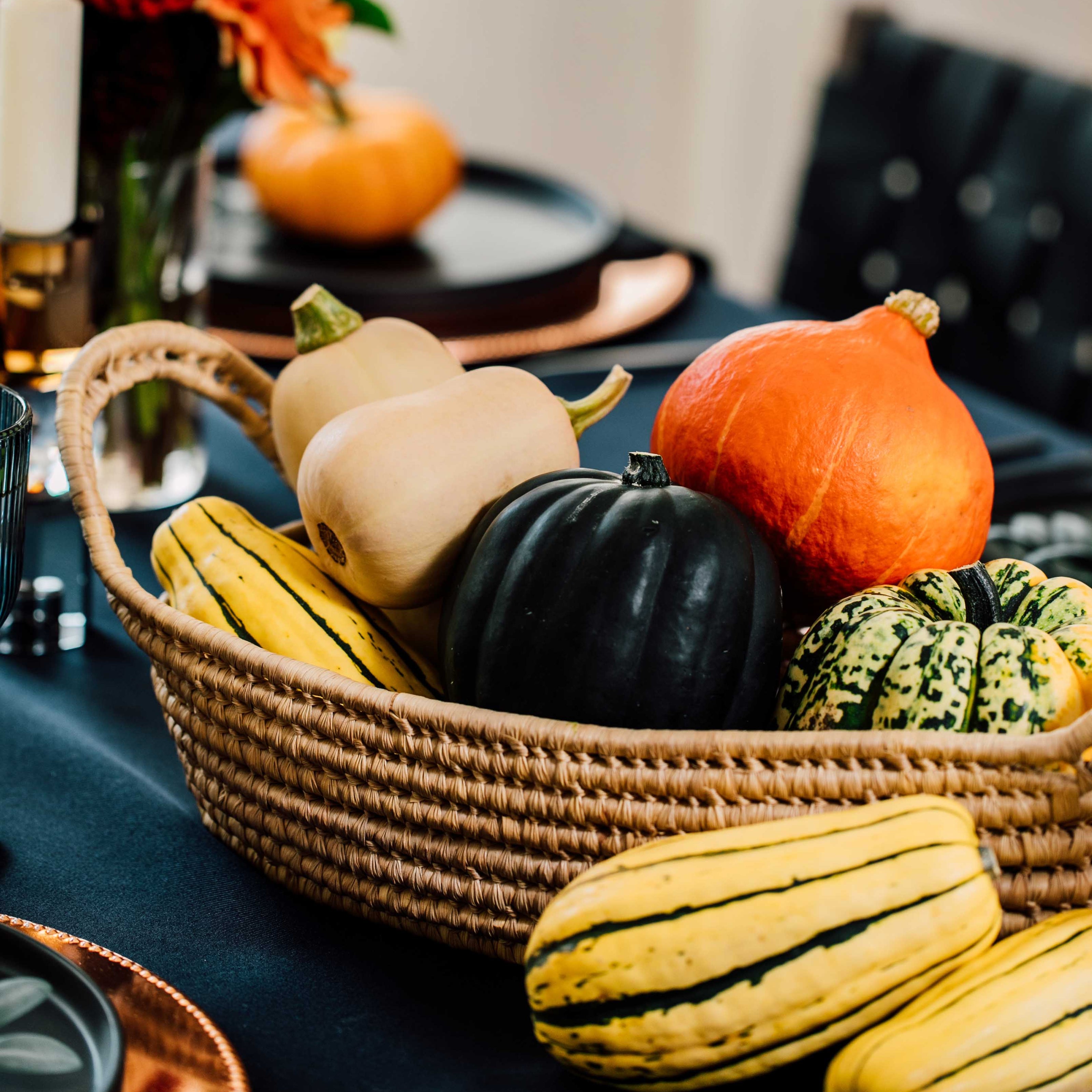 Basket of gourds on a table with a blurred background