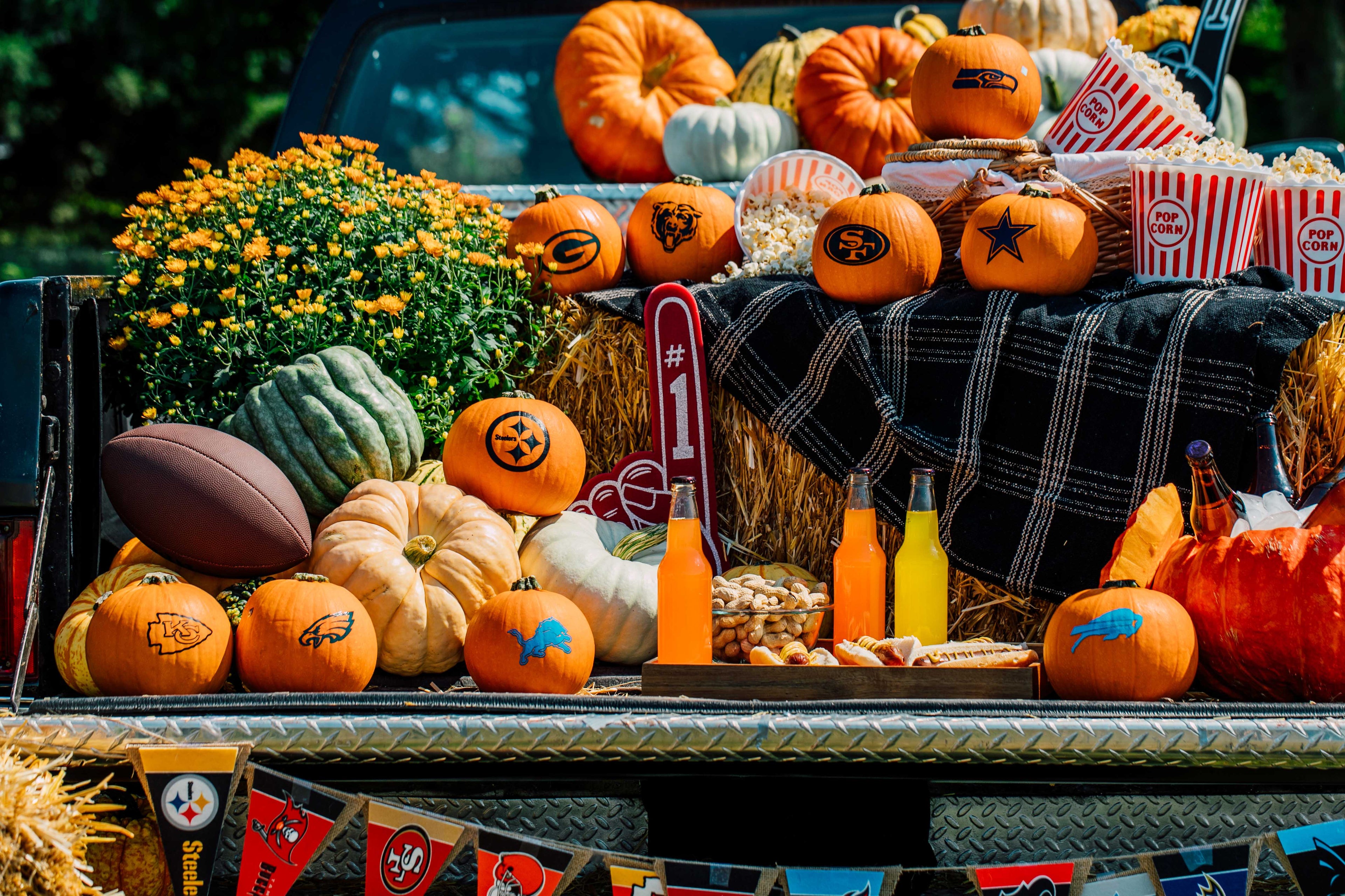 Decorated truck bed with pumpkins, gourds, and Halloween-themed items.